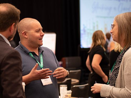 Summit Attendees Discussing Topics